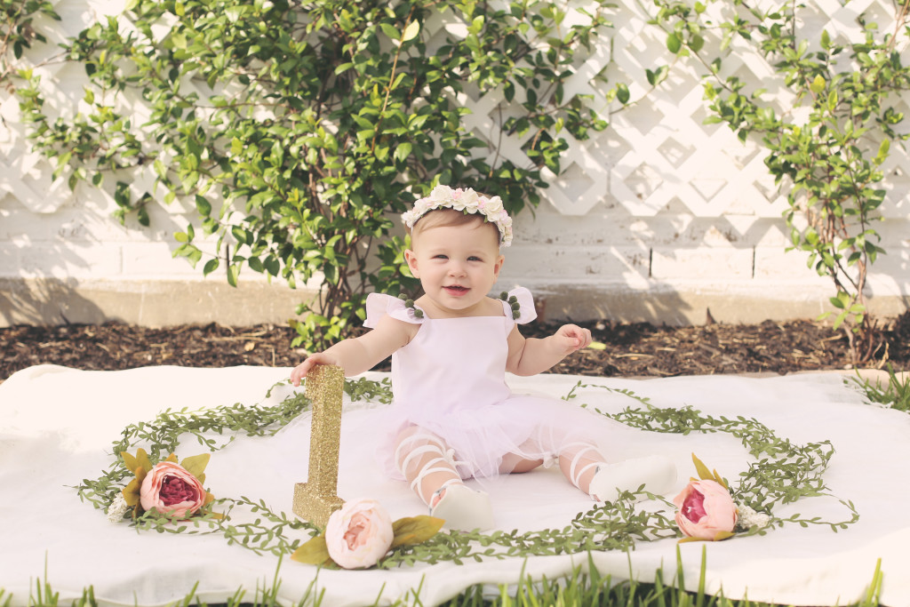 Lilyana's first birthday photoshoot and cake smash, featuring tutu romper with pompom trim from cuteheads