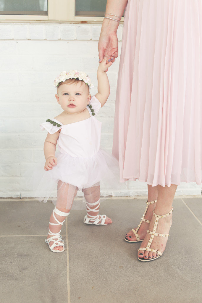 Lilyana's first birthday photoshoot and cake smash, featuring tutu romper with pompom trim from cuteheads