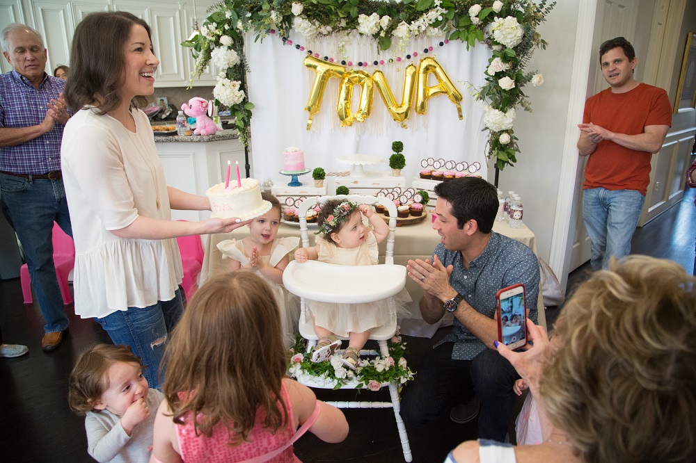 Tova's first birthday party cake smash with floral backdrop