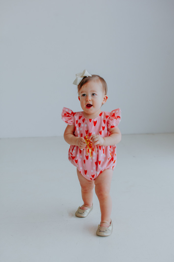 Our Favorite First Birthday Photoshoot Outfit Picks // Pink hearts bubble romper