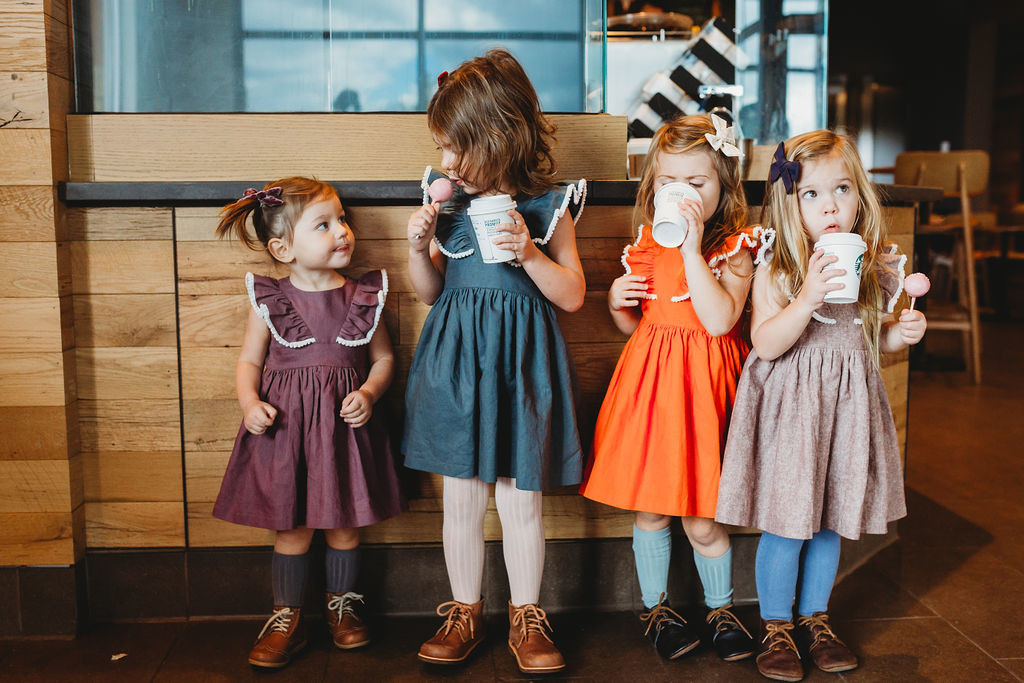 Little girls linen dresses with pom pom trim. Photo by Shannon Burdick. Available at cuteheads.com