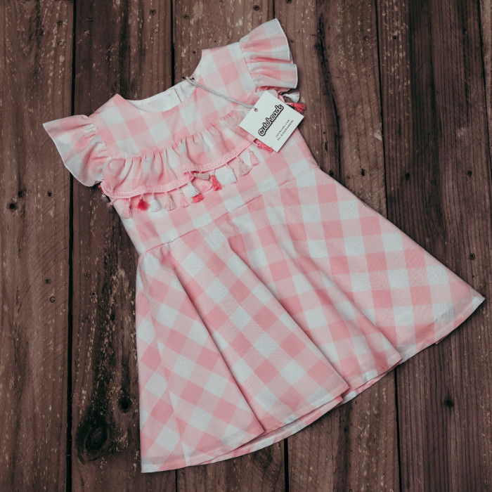Introducing a subscription box for girls that your daughter will love. Get a surprise dress in the mail every month! Learn more at cuteheads.com. // The cuteheads pink buffalo plaid tassel dress, only available in the Mystery Box!
